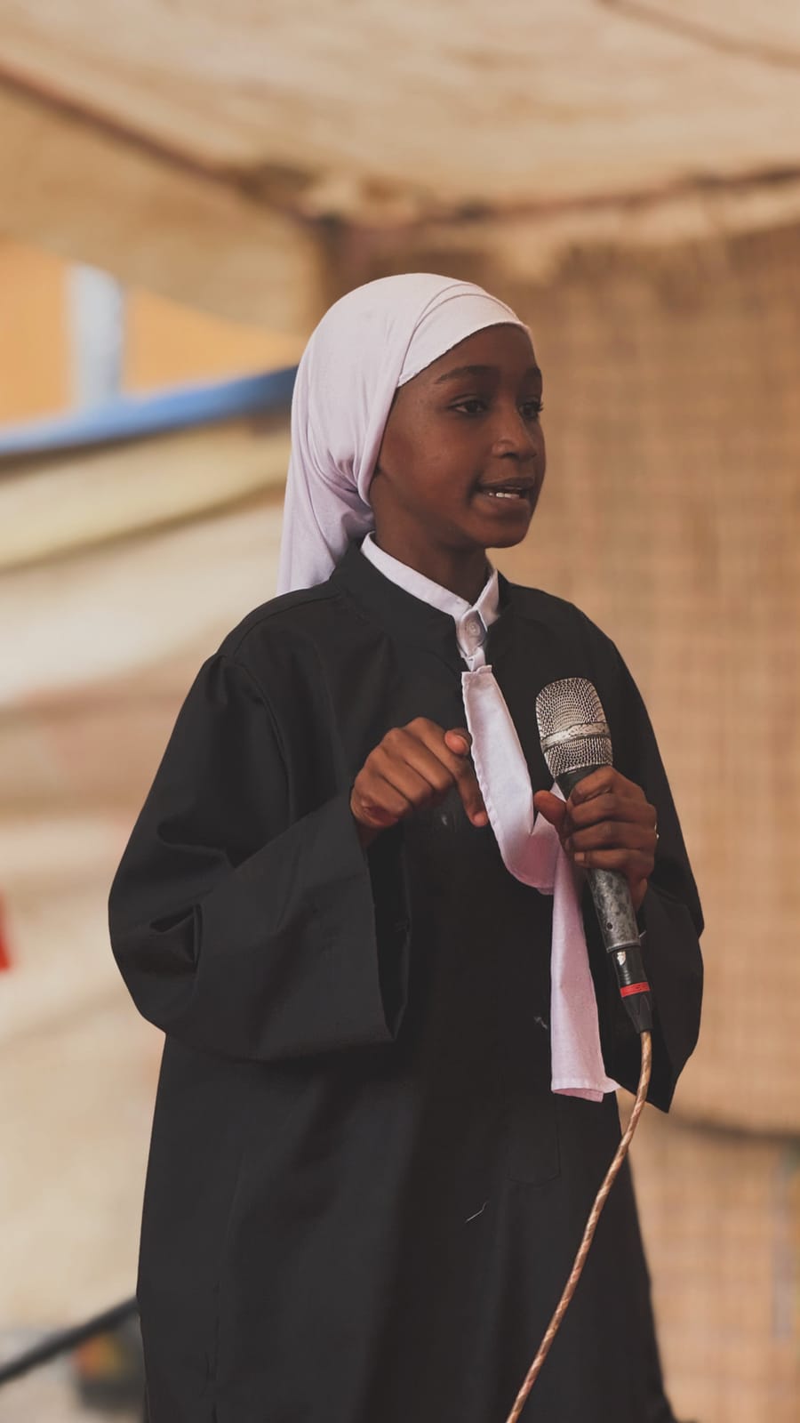 Élève prononçant un discours au micro – Fête de fin d’année